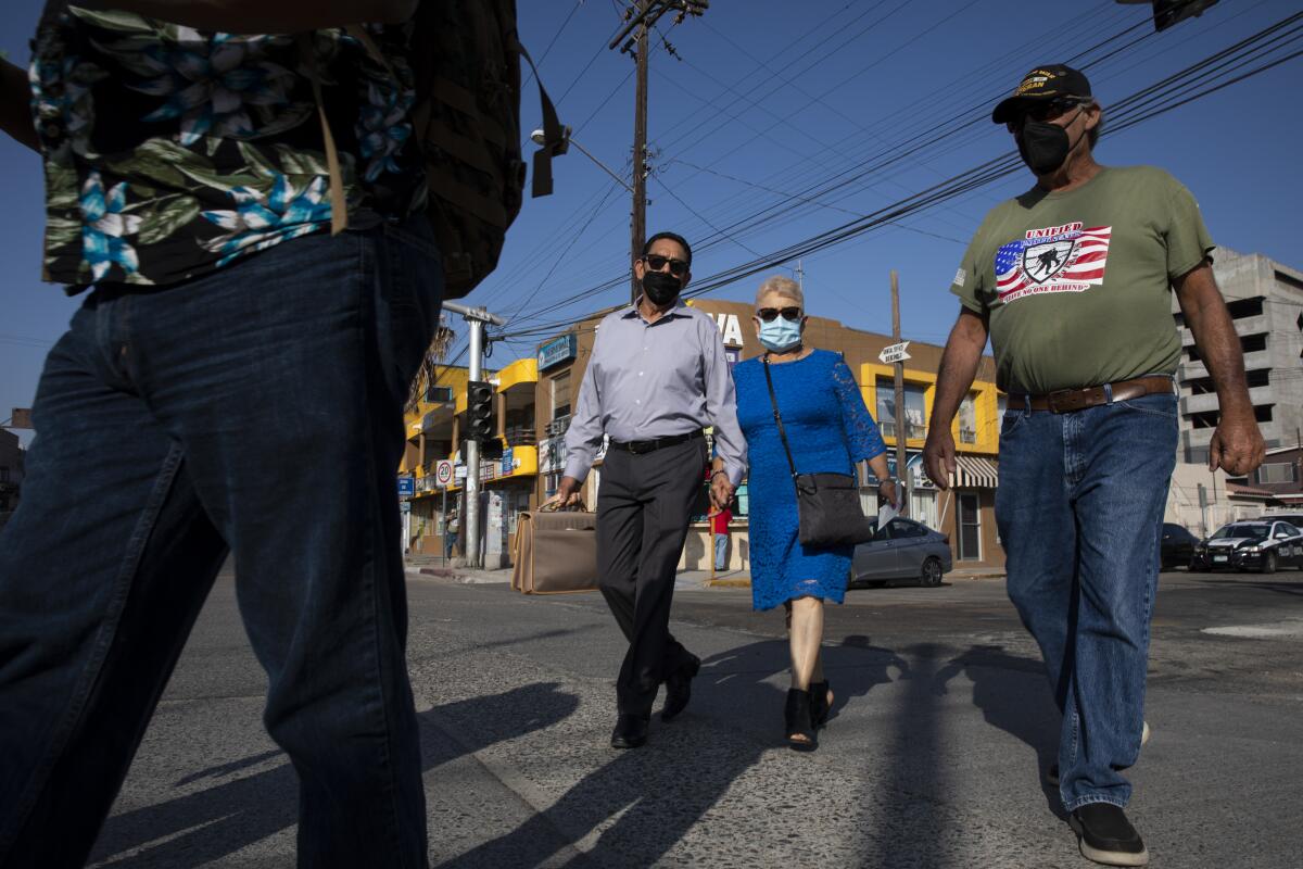 Agustin Abarca walks with with his wife, Rosalba, and Victor Hinojosa