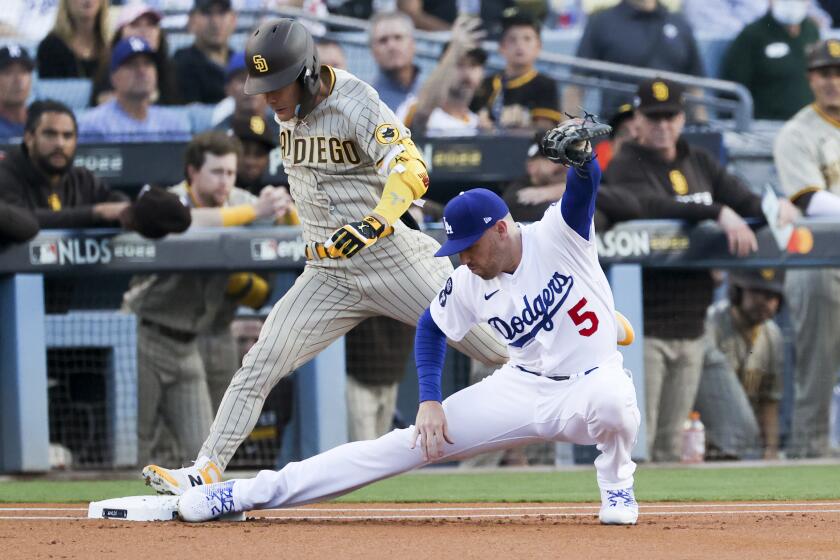 Los Angeles, CA - October 12: Los Angeles Dodgers first baseman Freddie Freeman, right, forces out San Diego Padres' Ha-Seong Kim at first base during the first inning in game two of the NLDS at Dodger Stadium on Wednesday, Oct. 12, 2022 in Los Angeles, CA.(Gina Ferazzi / Los Angeles Times)