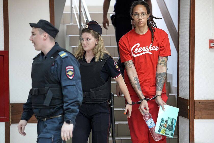 FILE - WNBA star and two-time Olympic gold medalist Brittney Griner is escorted to a courtroom for a hearing in Khimki just outside Moscow, on July 7, 2022. Russia has freed WNBA star Brittney Griner on Thursday in a dramatic high-level prisoner exchange, with the U.S. releasing notorious Russian arms dealer Viktor Bout. (AP Photo/Alexander Zemlianichenko, File)