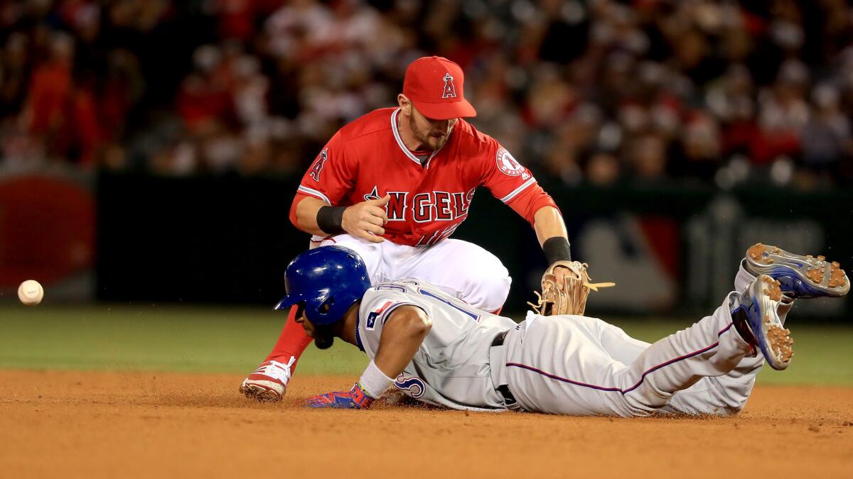 Second baseman Johnny Giavotella is unable to make the catch when the Angels tried to pick off the Rangers' Elvis Andrus during the seventh inning.