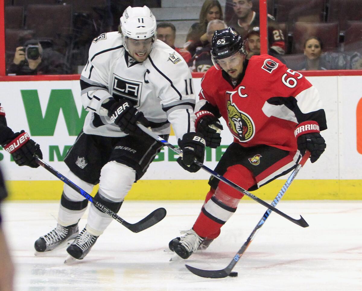 Senators defenseman Erik Karlsson (65) battles for the puck with Kings forward Anze Kopitar (11) during the first period on Nov. 11.