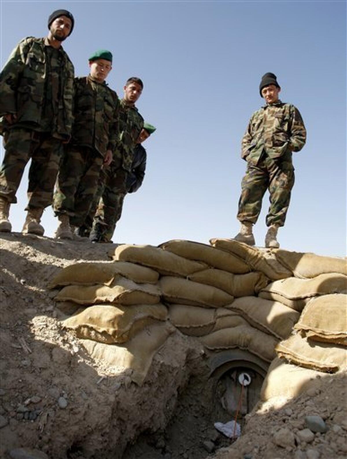 Afghan National Army soldiers look at the set up of an improvised explosive device (IED) during training at Camp Hero in Kandahar, southern Afghanistan Monday, Feb. 1, 2010. Those who specialize in clearing improvised explosive devices in Afghanistan are getting better at finding them before they go off, but it is a constantly evolving battle that exacts a high toll. (AP Photo/Kirsty Wigglesworth)