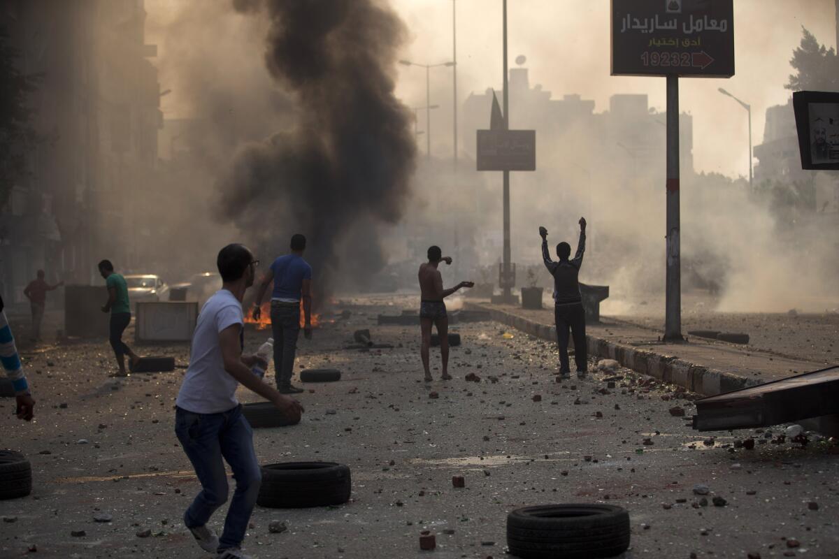 Supporters and opponents of Egypt's ousted Islamist President Mohamed Morsi clash in Cairo on Sunday.