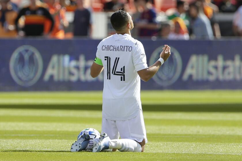 Los Angeles Galaxy forward Javier "Chicharito" Hernandez (14) prays at center field before the opening kick off of an MLS soccer match against the Houston Dynamo Saturday, Feb. 29, 2020, in Houston. (AP Photo/Michael Wyke)