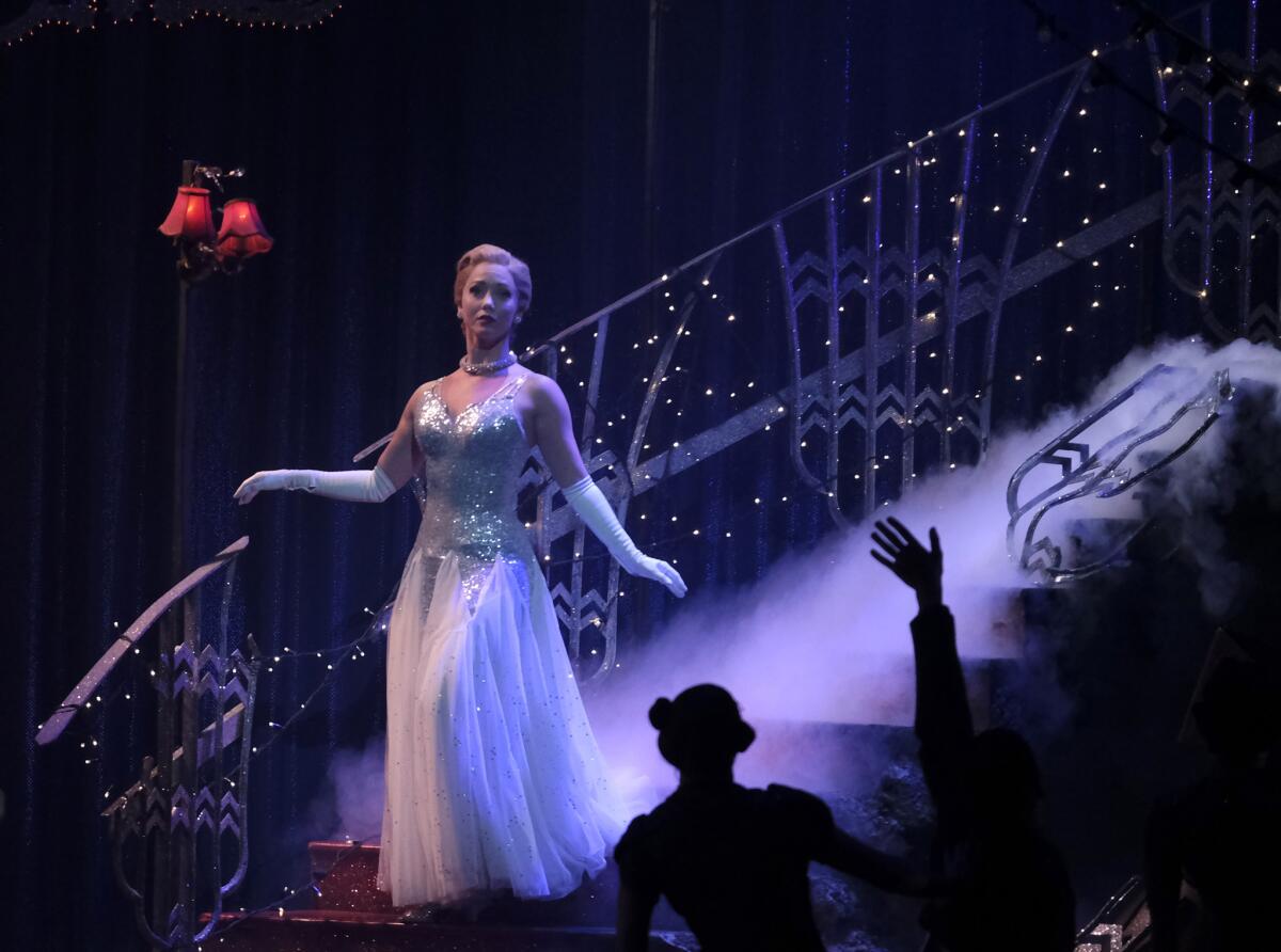 Cinderella (Ashley Shaw) descends the stairs at the ball in Matthew Bourne's reimagining of "Cinderella," now at the Ahmanson Theatre in Los Angeles through March 10.