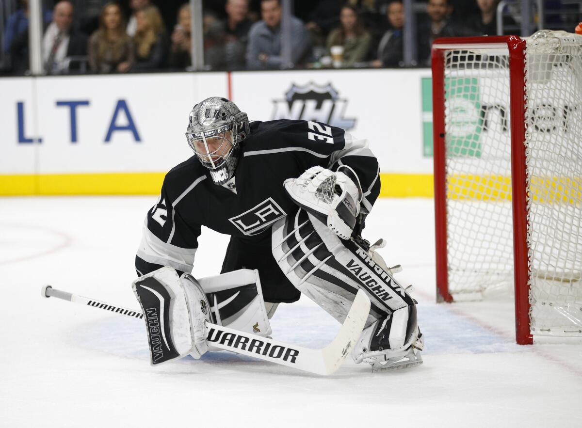 Kings goalie Jonathan Quick goes down to a knee in front of the net during the third period of a game against the Flyers.
