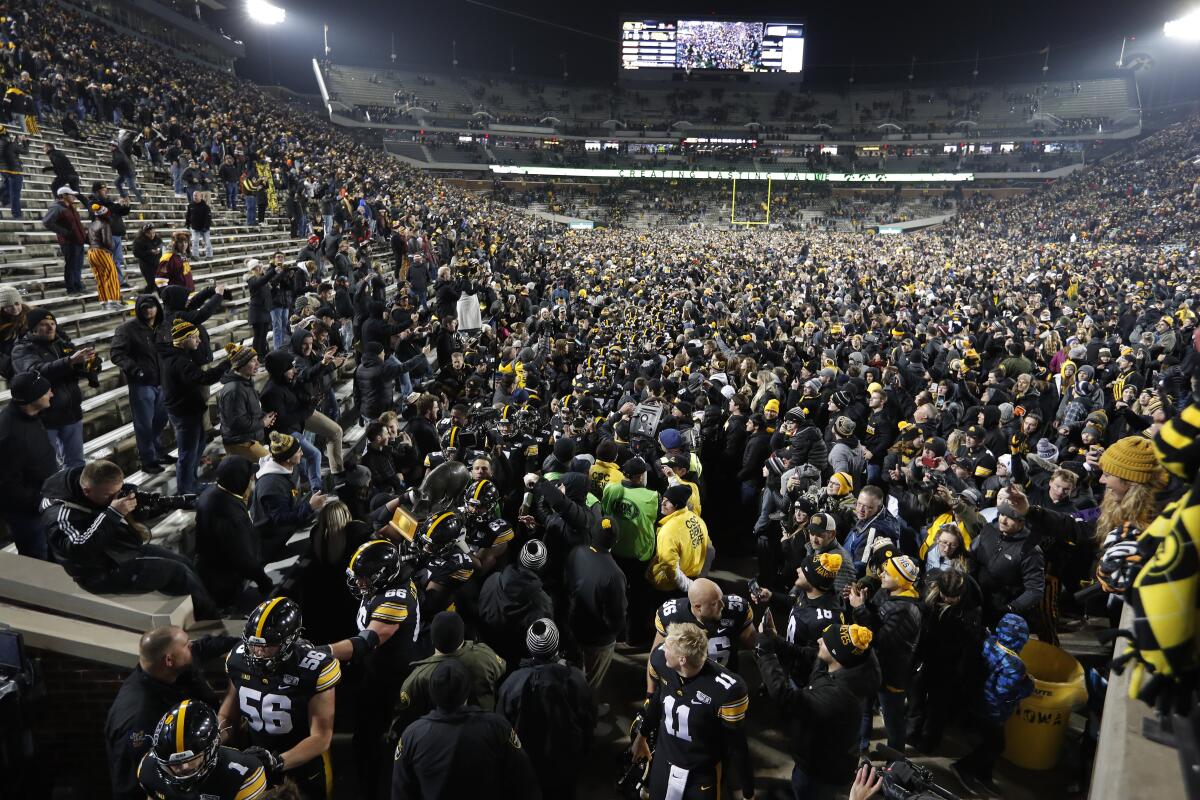 Iowa carries off the Floyd of Rosedale Trophy after defeating Minnesota on Saturday.