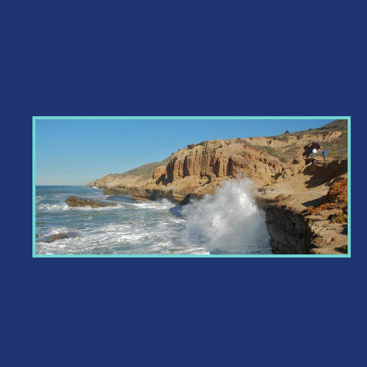 An image of ocean waves crashing into cliffs.