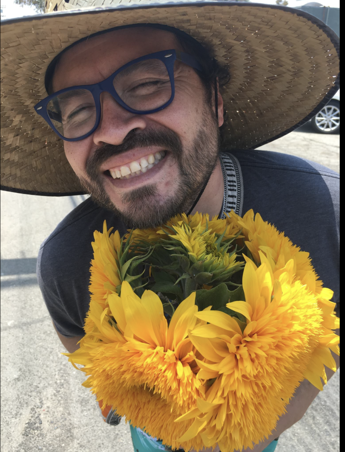 Edwin Aguilar holds a bouquet of flowers.