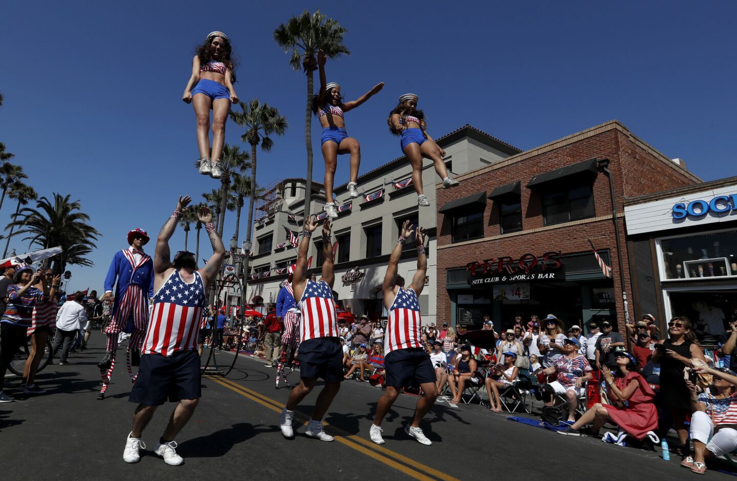 A drill team performs on Main Street during the annual Independence Day Parade in Huntington Beach.