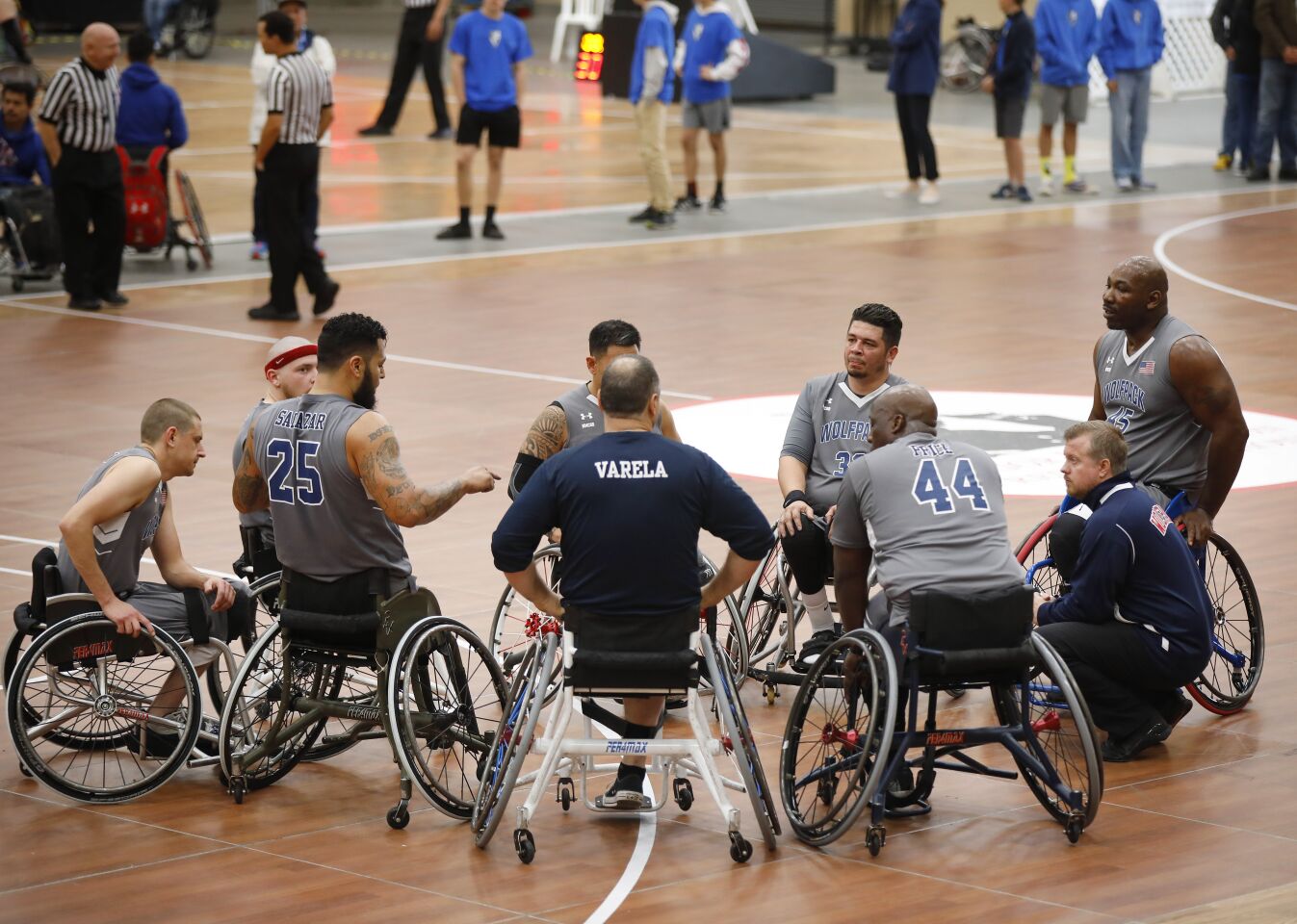 Naval Medical Center San Diego Wolfpack coach Scott Sutton, right, meets with his team during a game against the University of Arizona defend during the 4th Annual Brad Rich Invitational wheelchair basketball tournament at the Del Mar Fairgrounds on Feb. 9, 2020.
