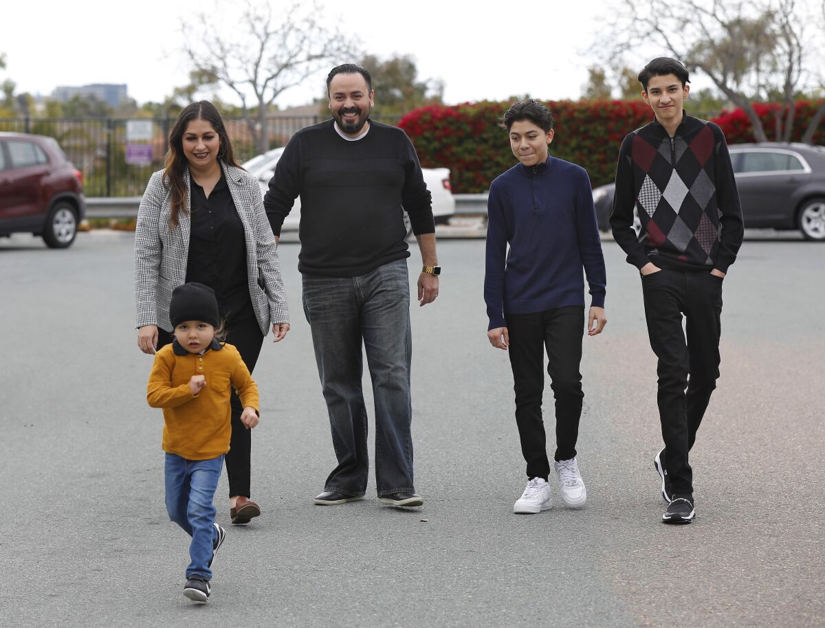 Erik Hoyo, his wife, Laura and their sons Ezekiel, 15, and Adrian, 17, right, were all sickened with Covid-19. Their son Mateo, 3, left, was not infected.