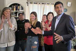 Rep. Ro Khanna (D-Fremont) speaks to a gathering of Biden supporters and press at a Concord home Saturday. Although Biden will not be on the Democratic primary ticket in New Hampshire Tuesday, surrogates like Khanna are swarming the state to get out the vote for the president anyway.