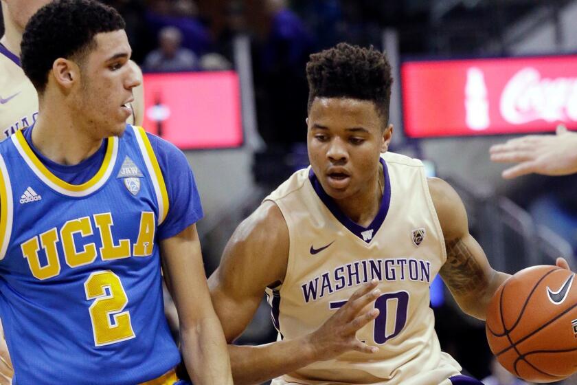 Washington's Markelle Fultz (20) is defended by UCLA's Lonzo Ball during the first half of an NCAA college basketball game Saturday, Feb. 4, 2017, in Seattle. (AP Photo/Elaine Thompson)