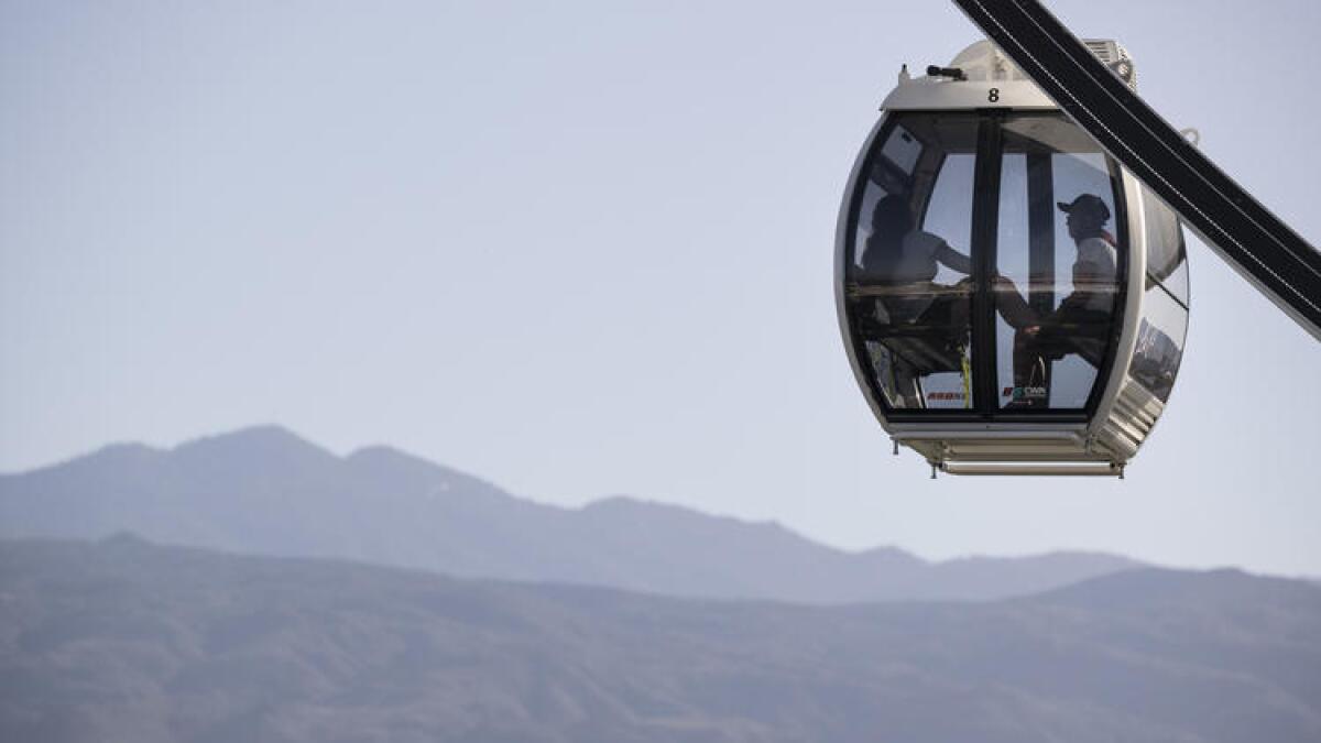 Coachella visitors ride the new air-conditioned ferris wheel at the first day of the Coachella Valley Music and Arts Festival in Indio on Friday.