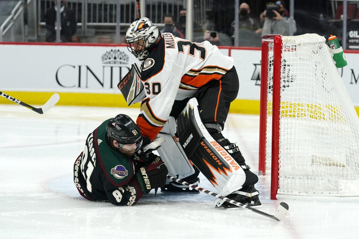 Ducks goaltender Ryan Miller and Arizona Coyotes right wing Phil Kessel get tangled up.