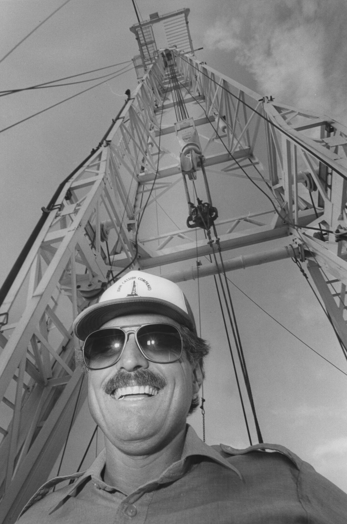 Dan Pena beneath an oil drilling platform in Texas.