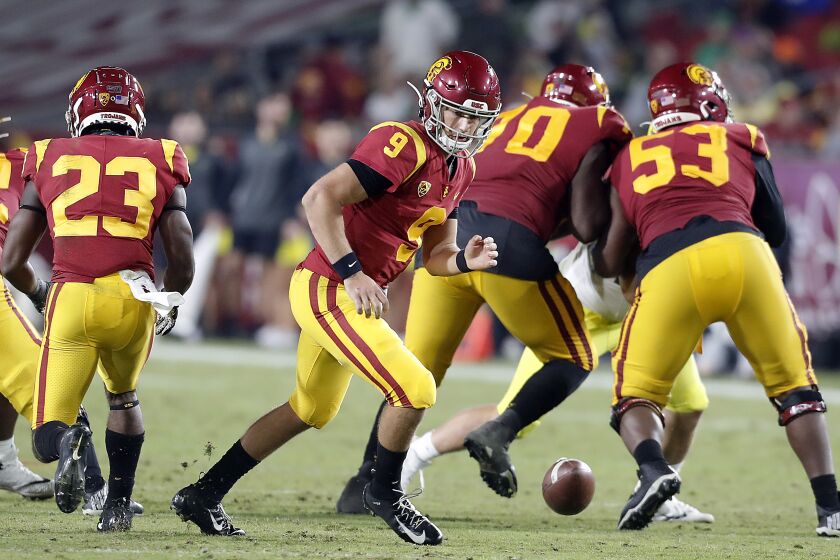 LOS ANGELES, CALIF. - OCT. 19, 2019. USC quarterback Kedon Slovis chases after a fumbled snap against Oregon in the fourth quarter at the Coliseum on Saturday night, Nov,. 2, 2019. (Luis Sinco/Los Angeles Times)