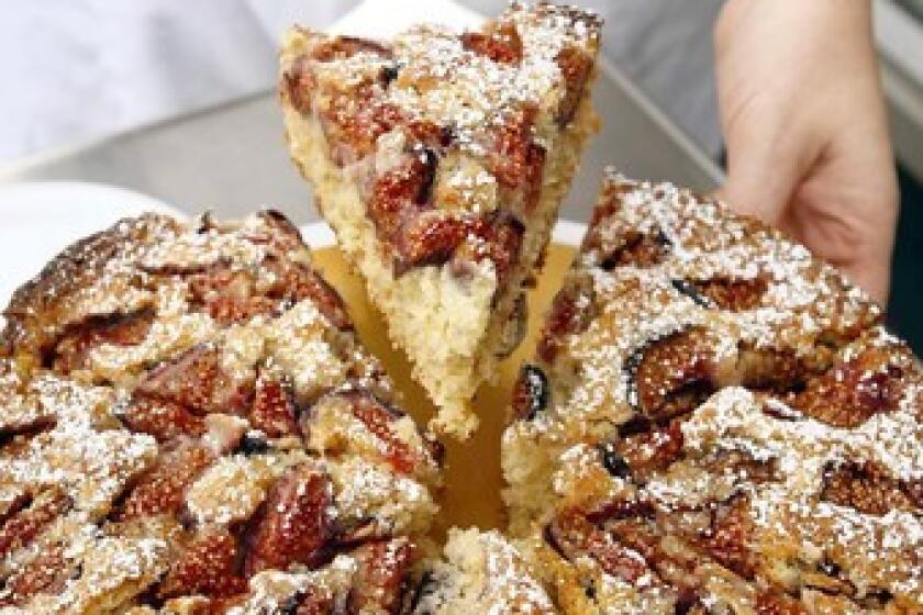 The rolled-oat cake with figs is sliced into servings at Proof Bakery in Atwater Village. Recipe