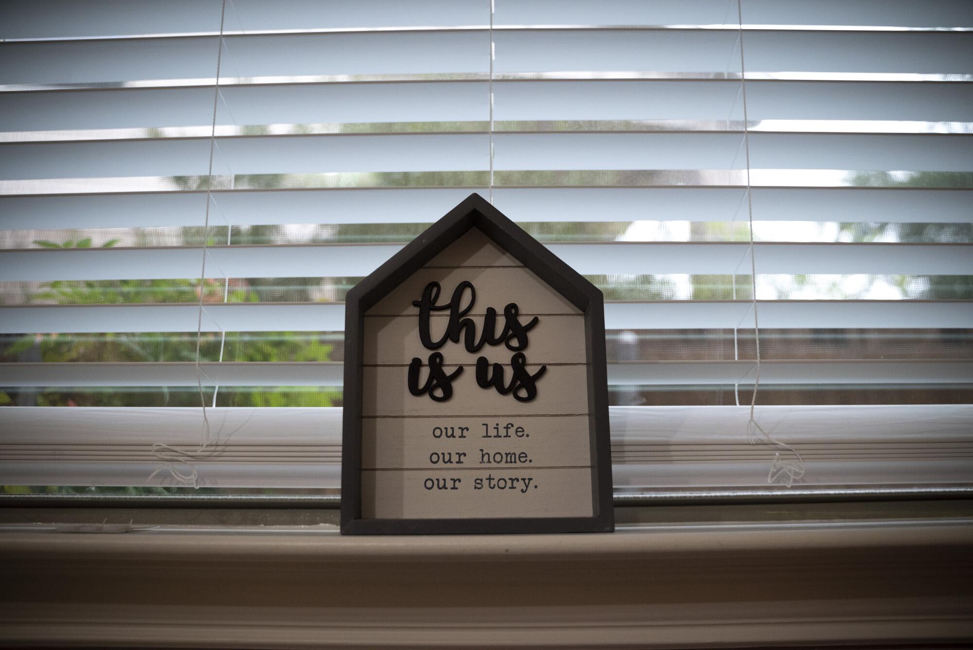 A sign inside a home says "This is us."