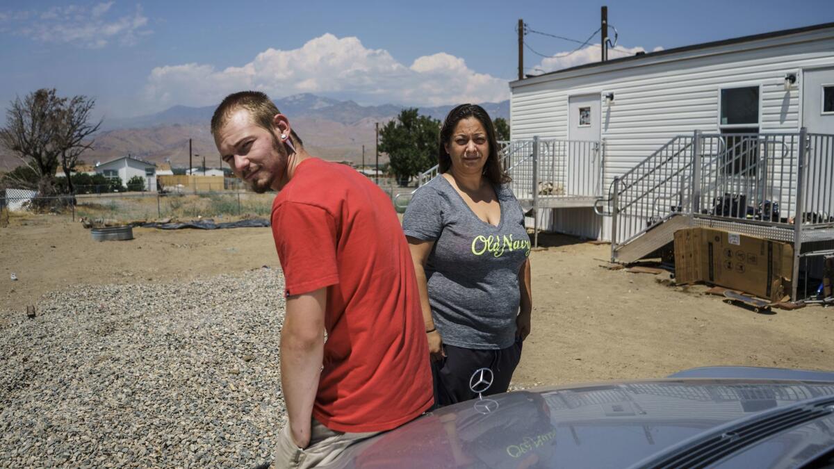 Melanie Perea and her boyfriend, Erik Kirby, outside their makeshift FEMA-provided trailer home in Lake Isabella.