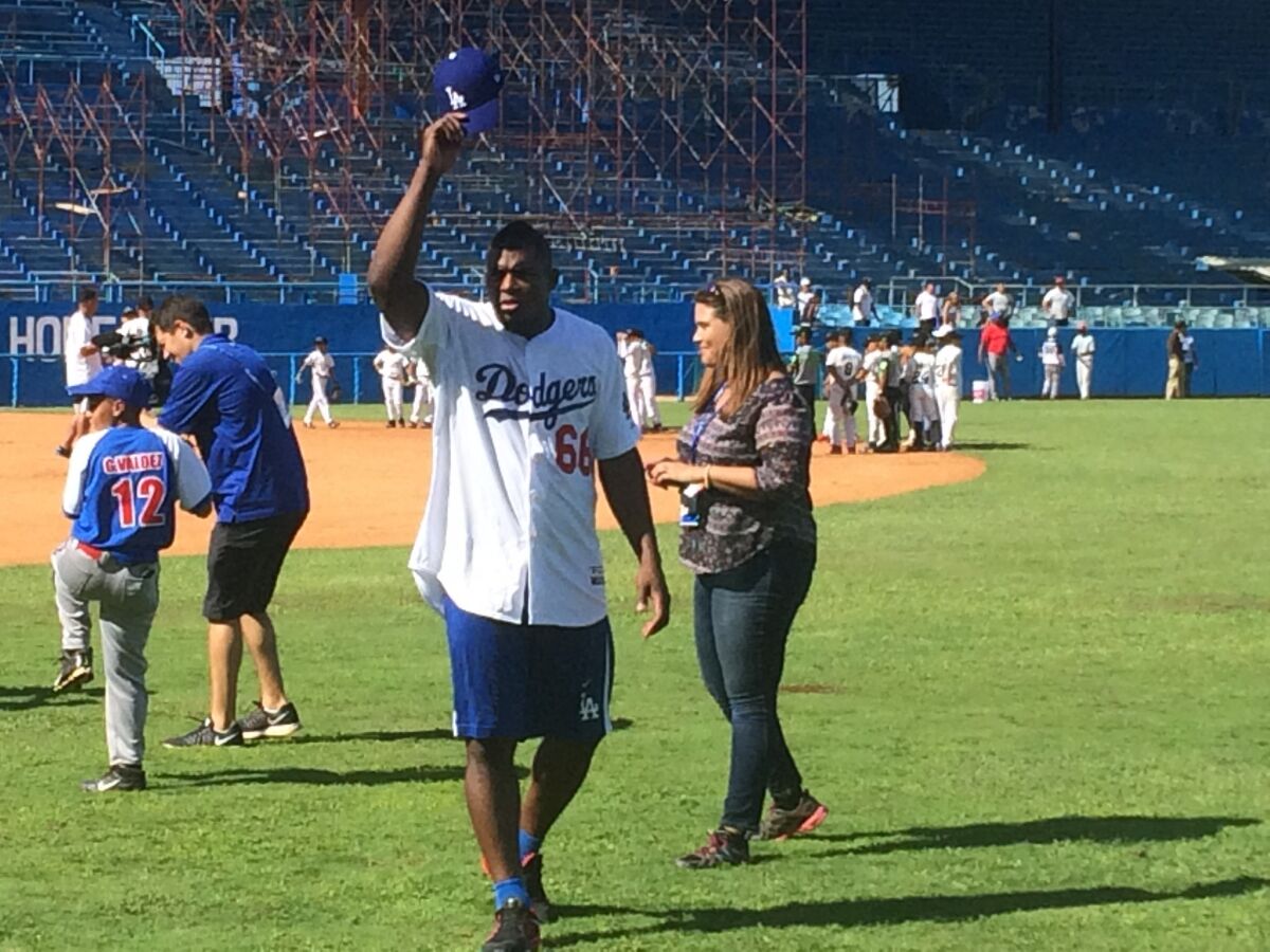 Dodgers outfielder Yasiel Puig tips his cap to the crowd during a MLB goodwill tour.