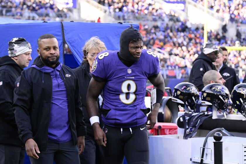 Baltimore Ravens quarterback Lamar Jackson (8) leaves the injury tent and heads toward the locker room, during the first half of an NFL football game against the Denver Broncos, Sunday, Dec. 4, 2022, in Baltimore. (AP Photo/Nick Wass)