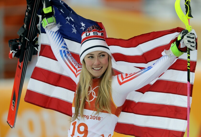 U.S. silver medal winner Mikaela Shiffrin poses during the flower ceremony.