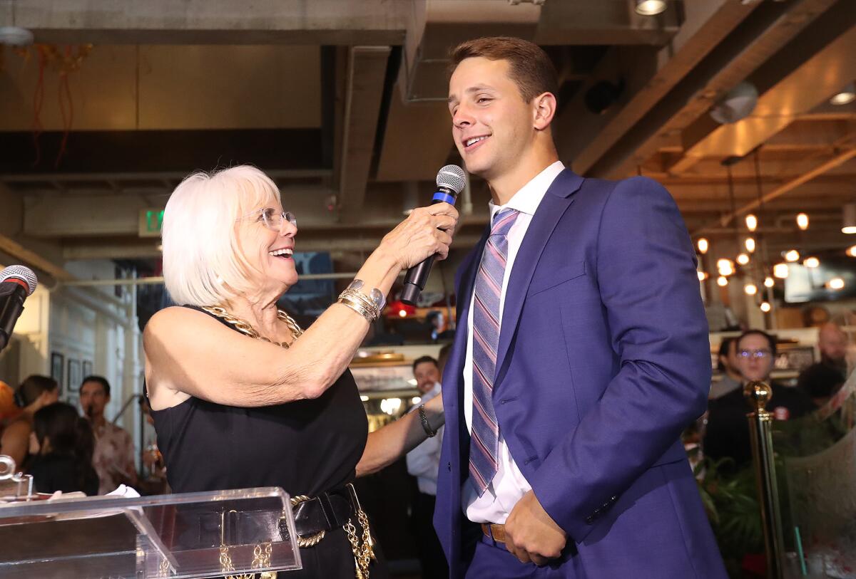 Brock Purdy is welcomed by Irrelevant Week CEO Melanie Salata Fitch as Mr. Irrelevant at the annual Lowsman Banquet.