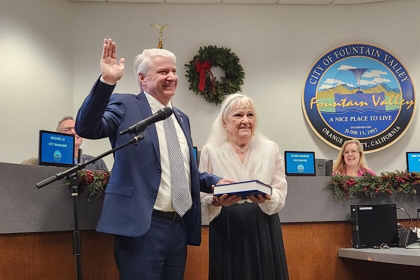 Glenn Grandis, left, with mother Pauline, is sworn in as mayor of Fountain Valley on Tuesday, Dec. 5, 2023.