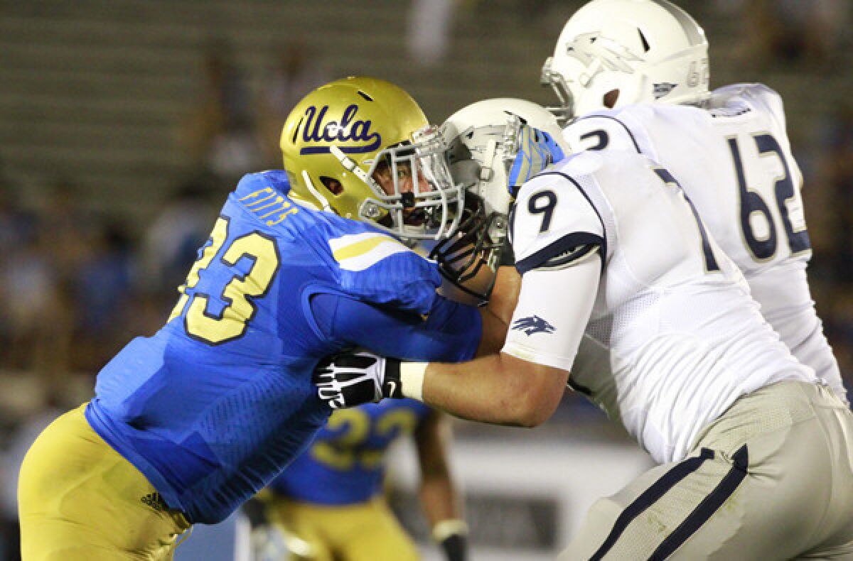 UCLA defensive lineman Kyle Fitts holds his ground against Nevada's Jacob Henry and Zach Brickell during the season-opening victory.