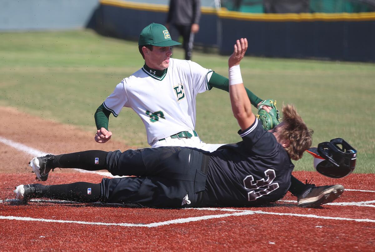 Huntington Beach's Matt Hansen (31) is tagged out by Edison pitcher Noah Hunter (38) on Tuesday.