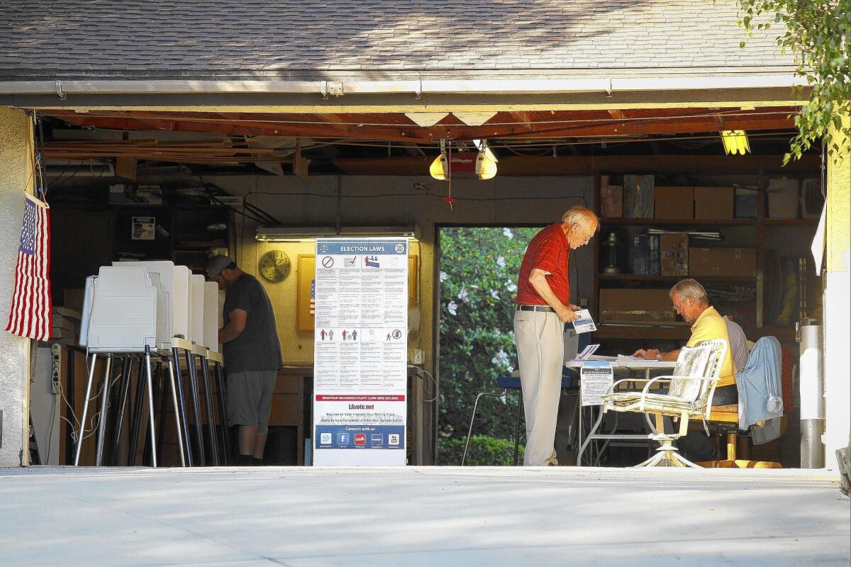 Voters cast their ballots for the California primary election at a polling place inside a garage near Covina. Republican candidates made surprisingly strong showings in several races.
