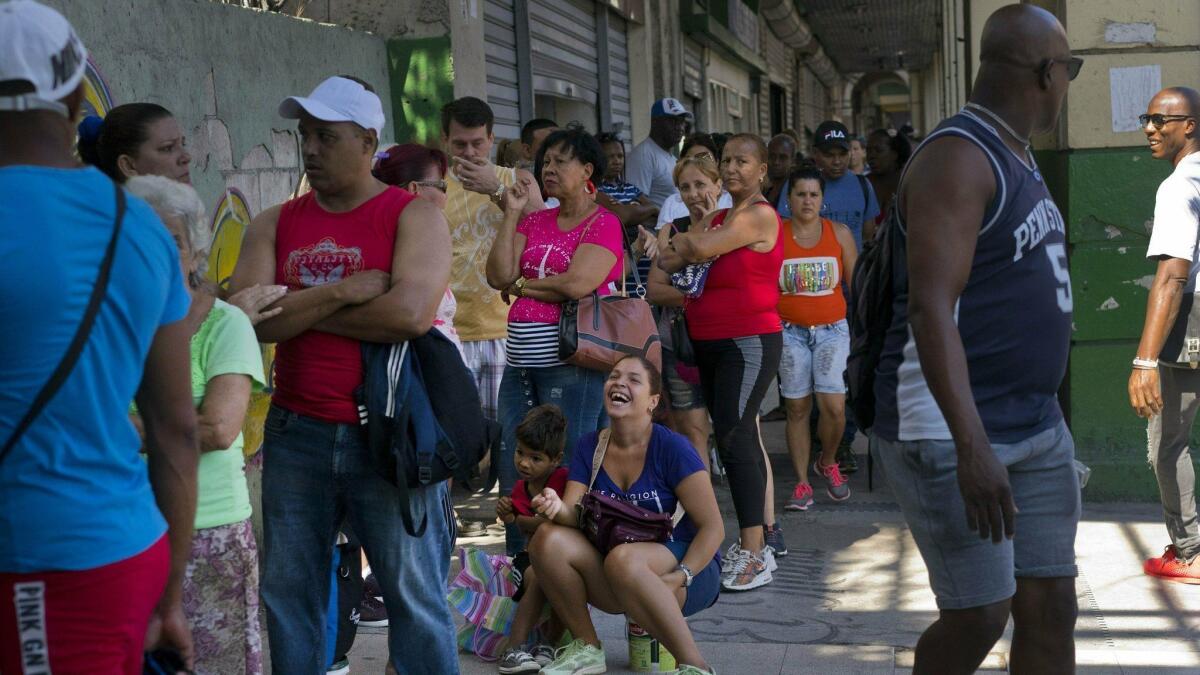 People wait to buy chicken April 17 at a government-run grocery store in Havana. Hours-long lines appear within minutes when trucks show up with new supplies, and shelves are soon empty again.