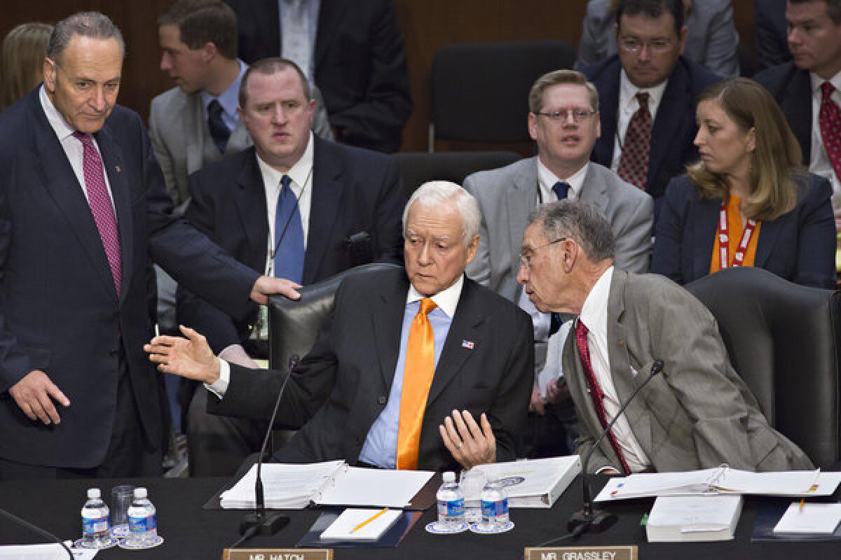 From left, Sen. Charles E. Schumer (D-N.Y.), Sen. Orrin G. Hatch (R-Utah) and Sen. Chuck Grassley (R-Iowa) confer as the Senate Judiciary Committee meets on immigration reform on Capitol Hill.