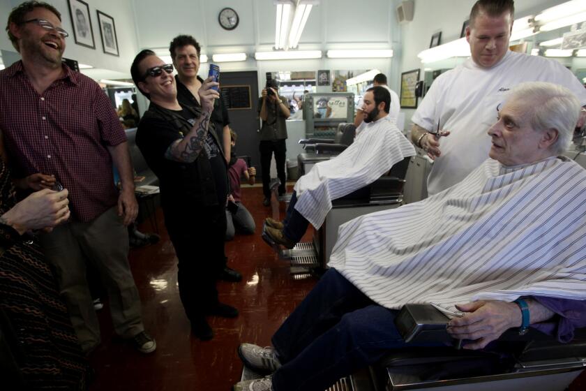 Harlan Ellison gets a haircut as fans watch before a 2013 book signing. The writer is recovering from a stroke he had last week.