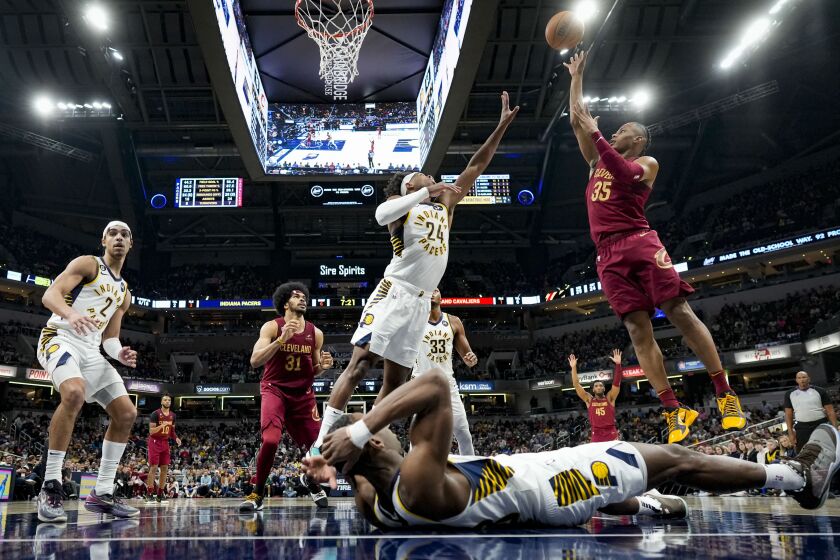 Cleveland Cavaliers forward Isaac Okoro (35) shoots over Indiana Pacers guard Buddy Hield (24) during the second half of an NBA basketball game in Indianapolis, Sunday, Feb. 5, 2023. The Cavaliers won 122-103. (AP Photo/AJ Mast)