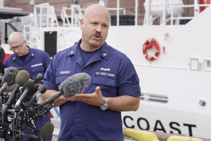 U.S. Coast Guard Capt. Jamie Frederick speaks to reporters during a news conference, Tuesday, June 20, 2023, at Coast Guard Base Boston. The U.S. Coast Guard says a search covering 10,000 square miles (26,000 square kilometers) has turned up no signs of a missing submersible off New England. Authorities made the announcement Tuesday. (AP Photo/Steven Senne)