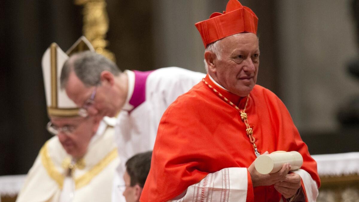 In this Feb. 22, 2014, photo, Cardinal Ricardo Ezzati, Archbishop of Santiago, Chile, holds his papal Bull of the Creation of Cardinals and wears the red three-cornered biretta hat during a consistory inside the St. Peter's Basilica at the Vatican.