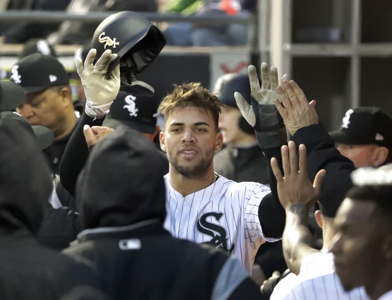 White Sox second baseman Yoan Moncada celebrates in the dugout after scoring on a hit by Avisail Garcia during the first inning against the Mariners, Monday, April 23, 2018.