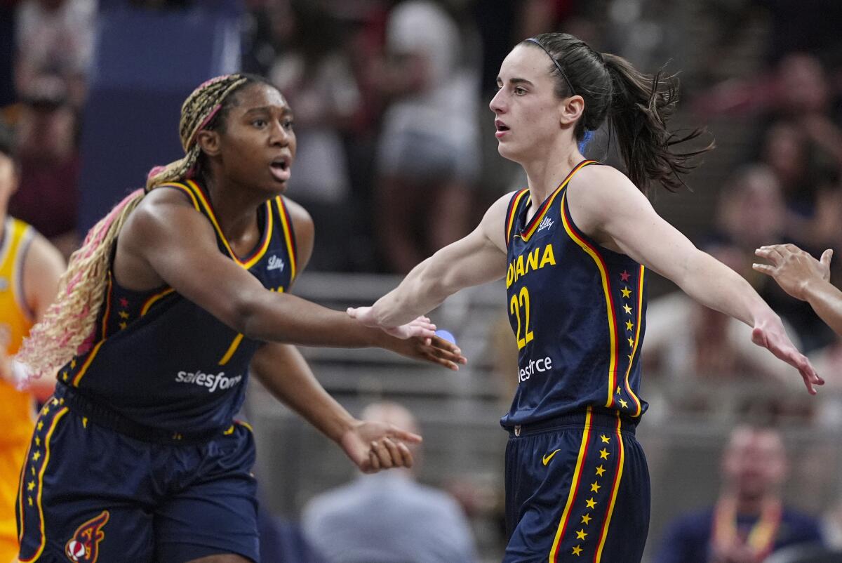 Indiana Fever guard Caitlin Clark (22) is congratulated by teammate Aliyah Boston