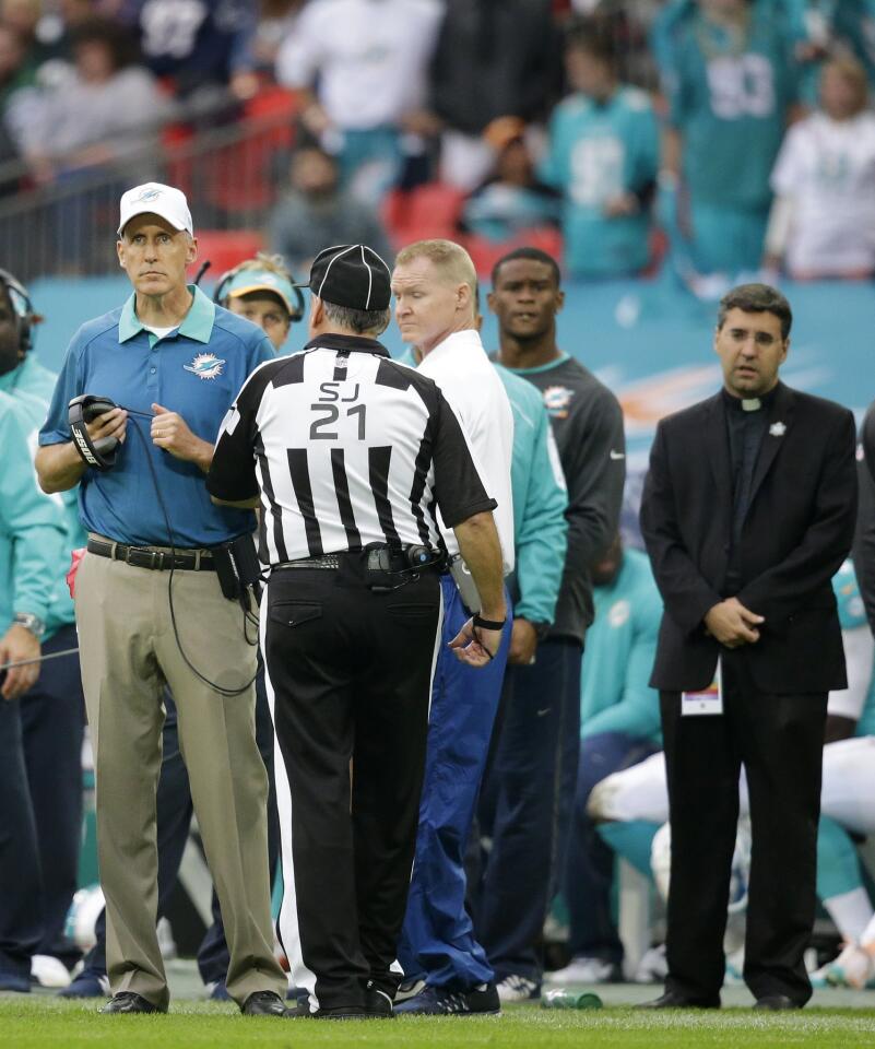 Miami Dolphins head coach Joe Philbin, left, watches from the touchline during the NFL football game between the New York Jets and the Miami Dolphins and at Wembley stadium in London, Sunday, Oct. 4, 2015. (AP Photo/Matt Dunham) ORG XMIT: WEM201
