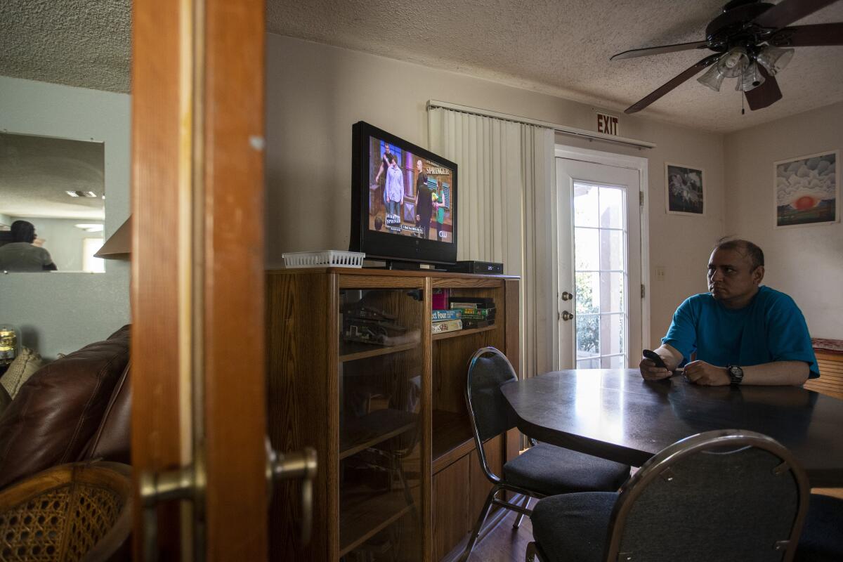 Louie Villalva, an eight-year resident of the Blake Home in Sylmar, watches "The Jerry Springer Show." Funding problems could cause the board-and-care home, and many others like it, to close.