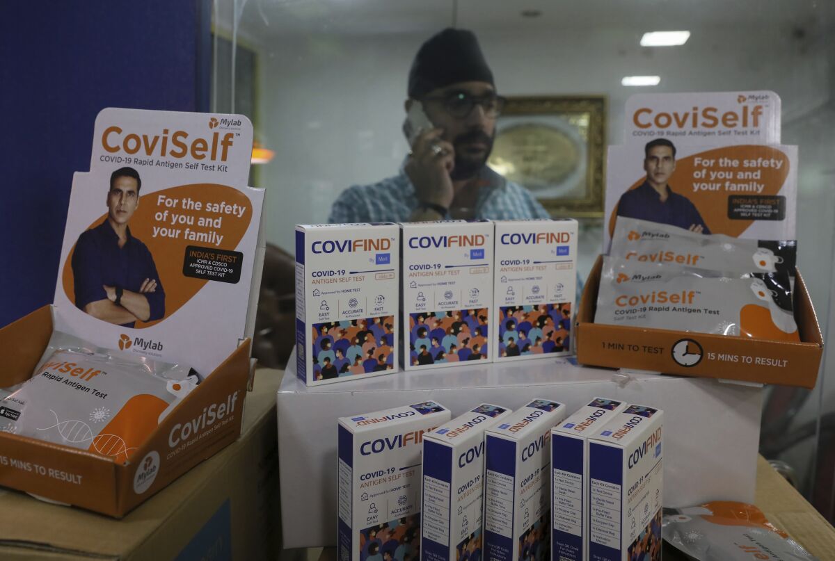 A wholesale vendor displays Rapid Antigen Test kits at his outlet in Hyderabad, India, Wednesday, Feb. 16, 2022. The use of rapid home tests has surged in India on the back of omicron cases, which have recently begun to decline. But experts have voiced caution, saying home tests are less accurate than lab-run PCR tests and that since not all results are being reported, new variants or future clusters may go undetected. (AP Photo/Mahesh Kumar A.)
