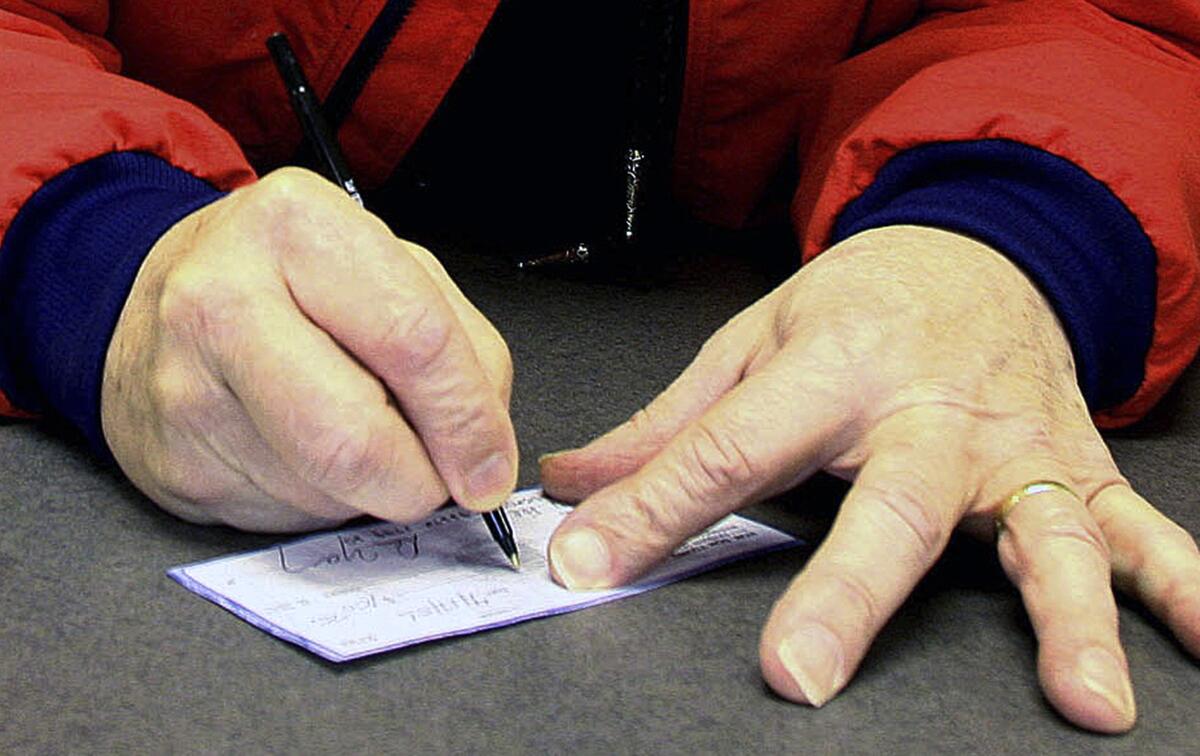 A man signs a check 