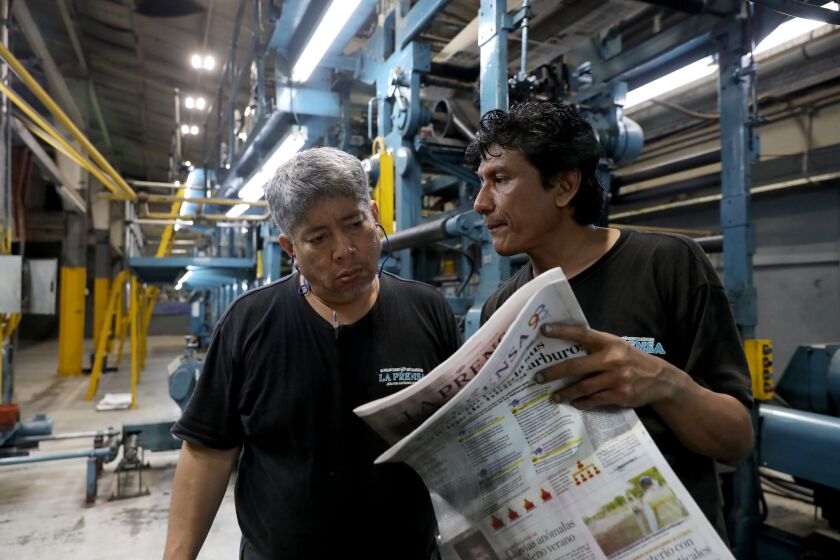 MANAGUA, NICARAGUA -- MONDAY, FEBRUARY 10, 2020: Jose Jimenez, press manager, and Jose Manuel Sosa in the press room at La Prensa newspaper in Managua, Nicaragua on Feb. 10, 2020. For 75-months President Daniel Ortega's autocratic regime had been holding up in General Directorate of Customs (DGA) roughly half a million dollars of La Prensa’s, in publication for 93-years, two most essential ingredients: paper and ink. (Gary Coronado / Los Angeles Times)