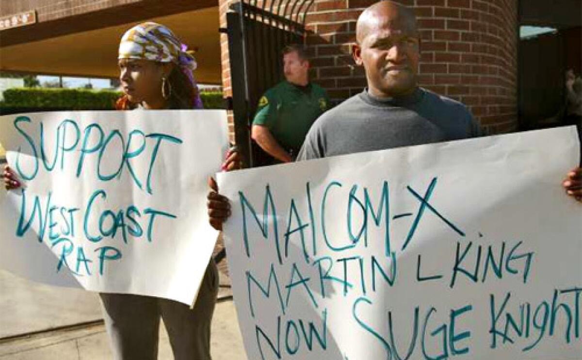 PROTEST: Rap artists Lady Nieya and LA Nash express their views outside the Beverly Hills office of Tha Row Records, one of many targets of Thursday's sweep.