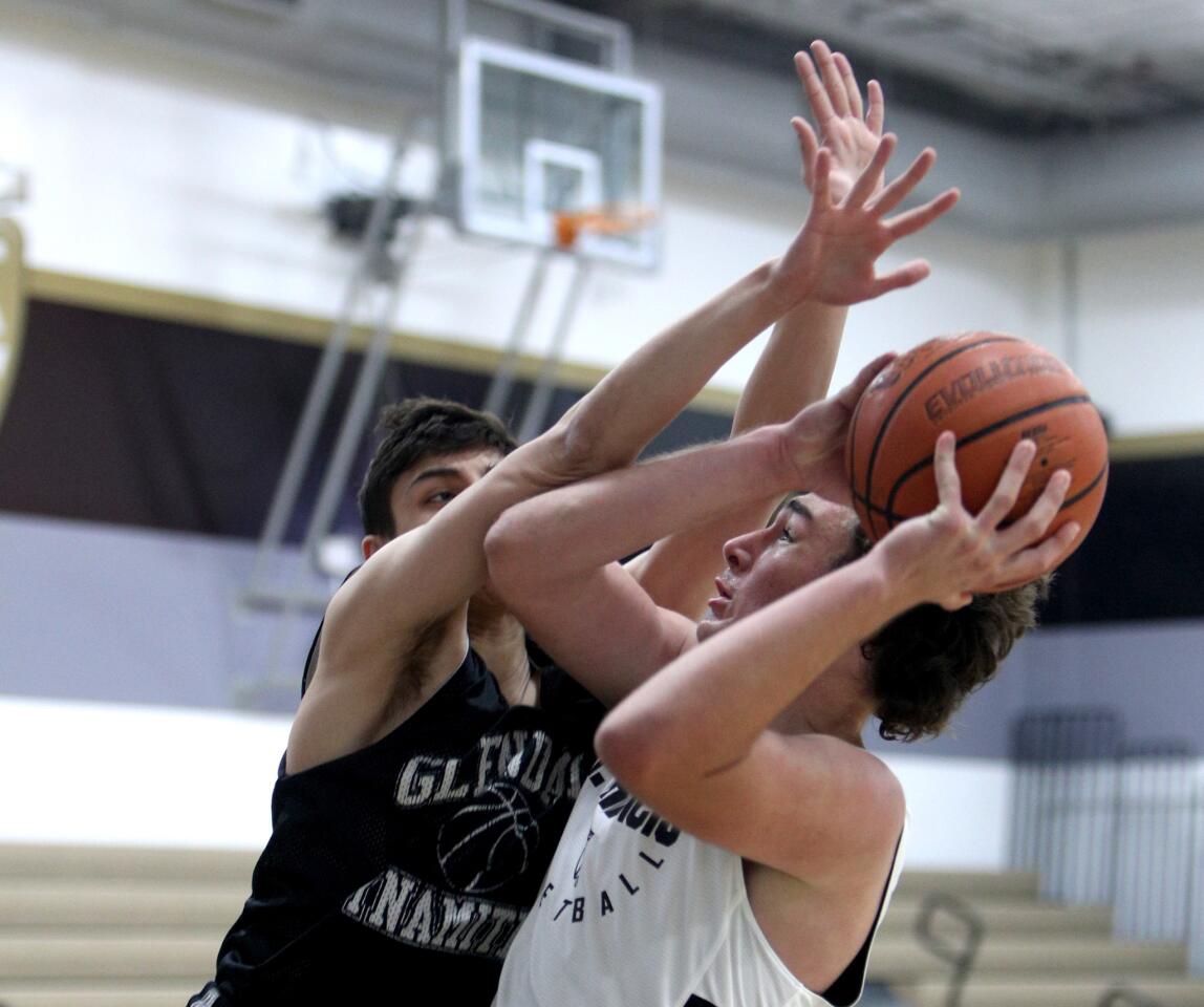 St. Francis High School player Dexter Assa takes a shot under pressure from Manny Kapoushian in game vs. Glendale High School in the L.A. Court Report Varsity Summer Shootout at St. Francis High School in La Canada Flintridge on Friday, June 7, 2019.