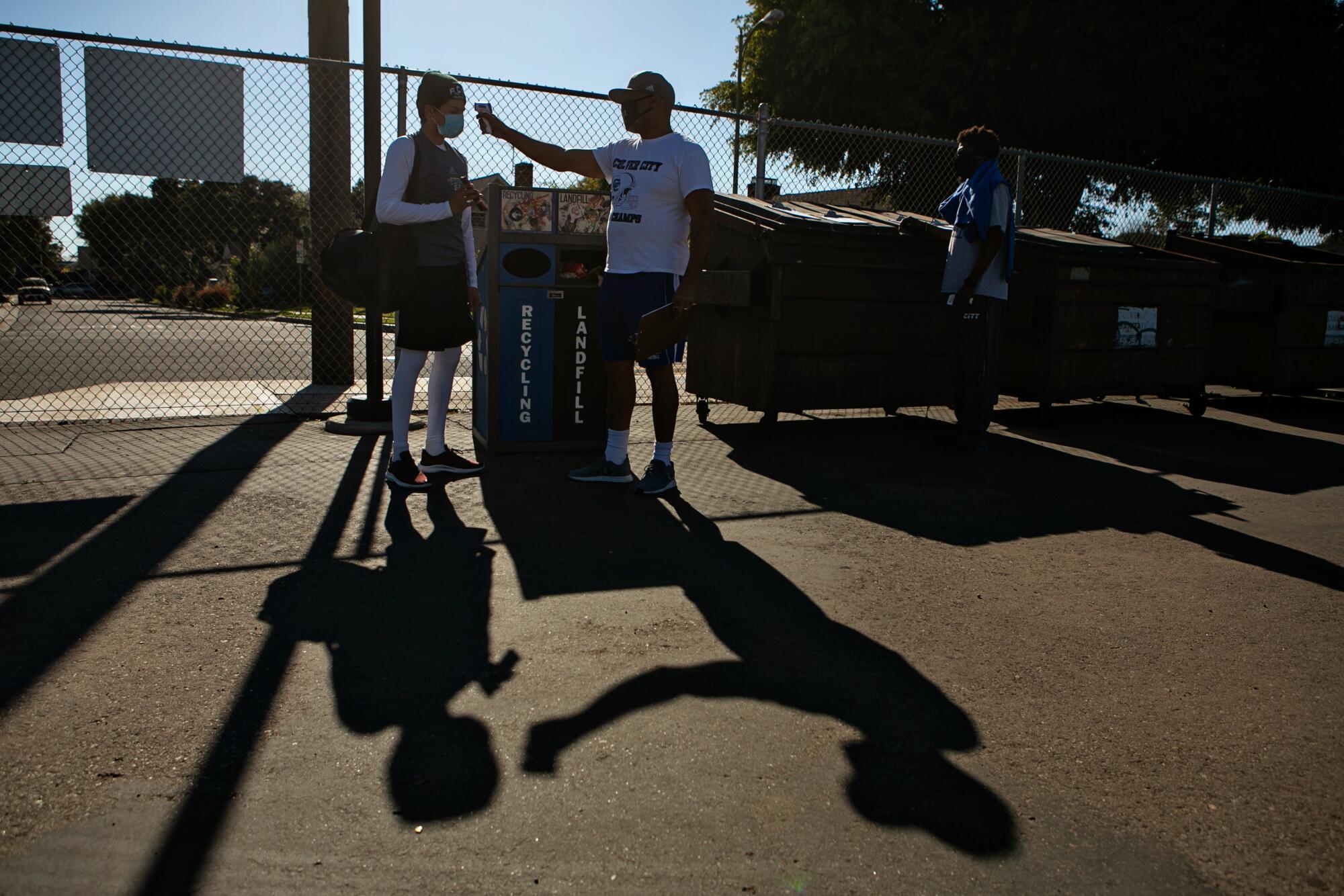 Culver City players have their temperature checked before the first practice.