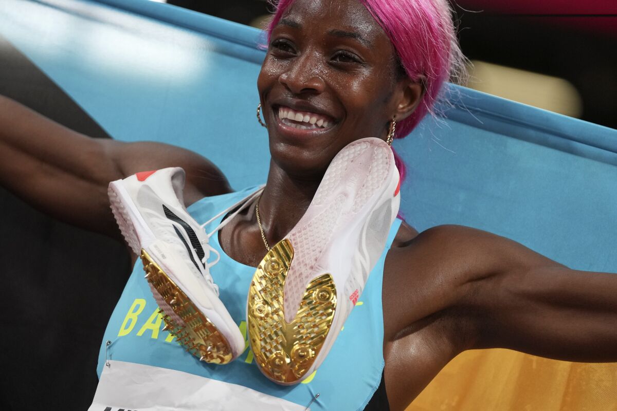 Shaunae Miller-Uibo, of the Bahamas, celebrates after winning the gold medal in the women's 400-meter final at the 2020 Summer Olympics, Friday, Aug. 6, 2021, in Tokyo. (AP Photo/Matthias Schrader)